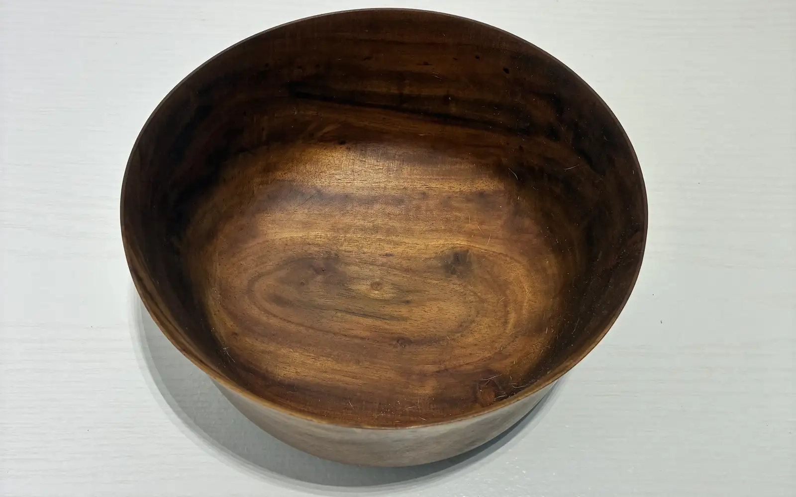 Kaleb’s flared milo bowl from above, the grain swirling dark and gold inside it
