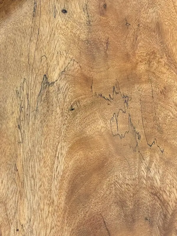 Close in on mango in Kaleb’s spalted bowl: golden grain crossed by the fine black lines of spalting