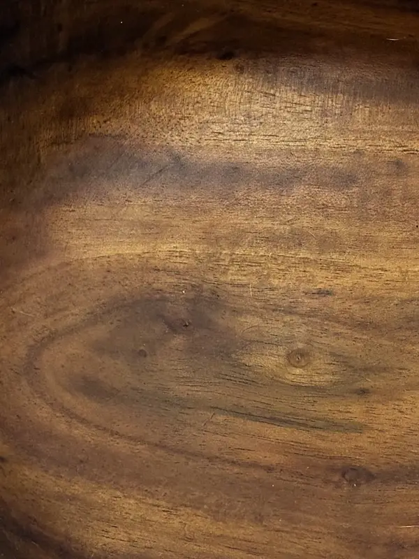 Close in on milo in Kaleb’s flared bowl: brown heartwood with darker streaks and a small knot