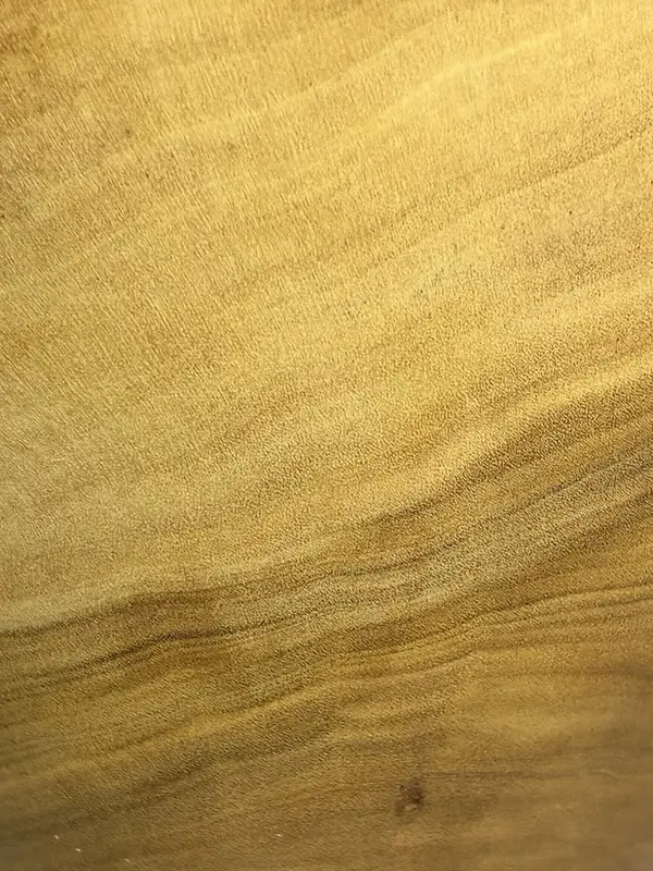 Close in on naio in Kaleb’s bowl: pale gold, fine-grained wood with soft darker streaks