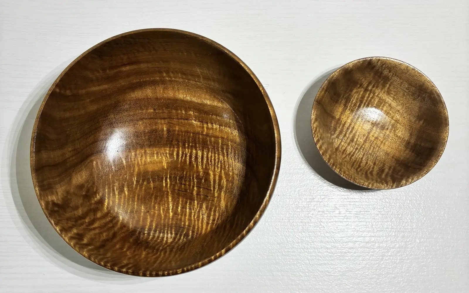 Kaleb’s curly koa pair from above, the curl shimmering across both bowls